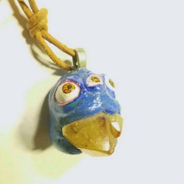 Hand sculpted clay creature pendant